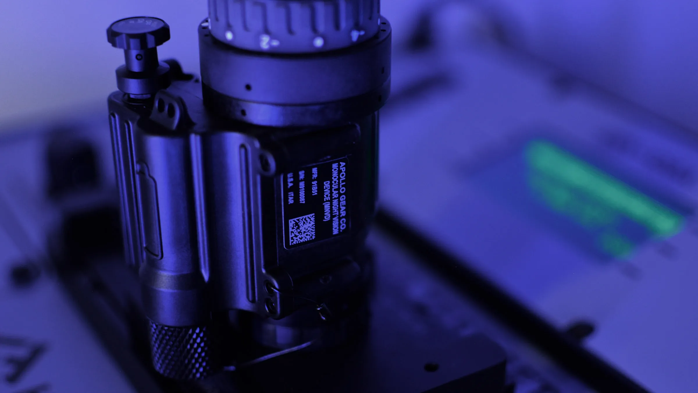 Apollo-branded night-vision device photographed under blue light.